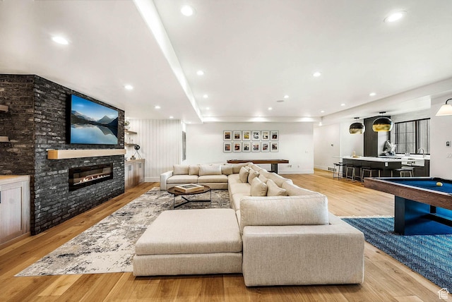 2225 Elk Meadows Cir, Woodland, UT 84036 - living room with light wood-style floors, a glass covered fireplace, billiards, and recessed lighting