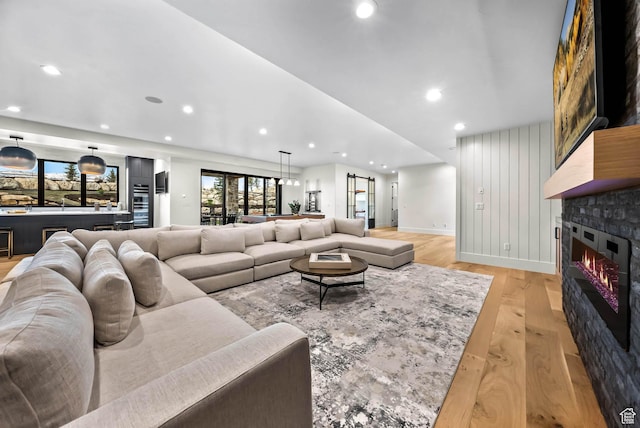 2225 Elk Meadows Cir, Woodland, UT 84036 - living room with light wood-type flooring, recessed lighting, and a glass covered fireplace