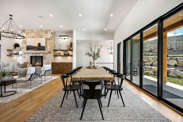 2225 Elk Meadows Cir, Woodland, UT 84036 - dining space with a chandelier, light wood-style floors, a stone fireplace, and recessed lighting