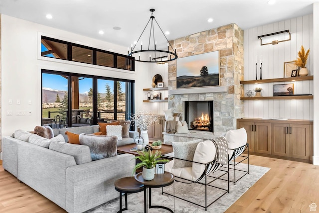 2225 Elk Meadows Cir, Woodland, UT 84036 - living area featuring light wood-type flooring, a chandelier, a stone fireplace, and recessed lighting