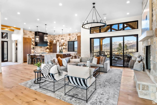 2225 Elk Meadows Cir, Woodland, UT 84036 - living area with recessed lighting, a high ceiling, a chandelier, a mountain view, and light wood-type flooring