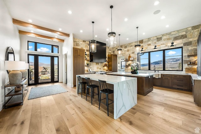 2225 Elk Meadows Cir, Woodland, UT 84036 - kitchen featuring ventilation hood, a spacious island, recessed lighting, light wood-style floors, and a breakfast bar area