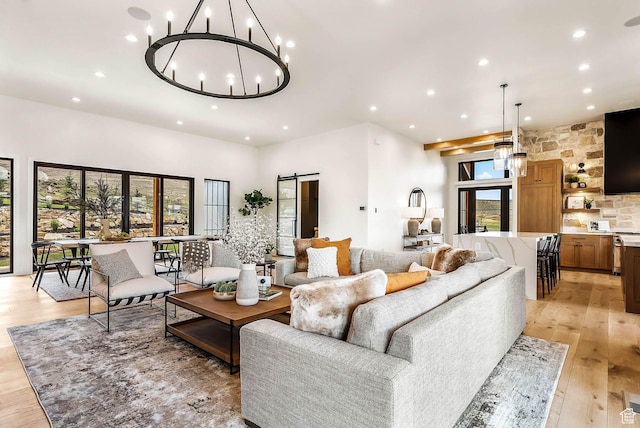 2225 Elk Meadows Cir, Woodland, UT 84036 - living room with recessed lighting, a chandelier, light wood-style floors, and a barn door