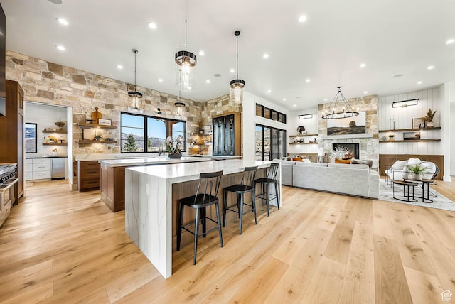 2225 Elk Meadows Cir, Woodland, UT 84036 - kitchen featuring a large island with sink, light wood finished floors, light countertops, a breakfast bar, and recessed lighting