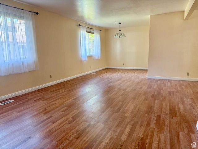 34 S El Dorado Pl, West Jordan, UT 84088 - spare room with a chandelier and light wood-style floors