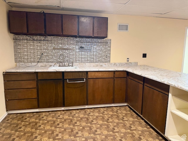 34 S El Dorado Pl, West Jordan, UT 84088 - kitchen featuring backsplash, dark brown cabinets, and light stone countertops