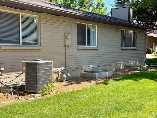 34 S El Dorado Pl, West Jordan, UT 84088 - view of side of property featuring a lawn and a chimney