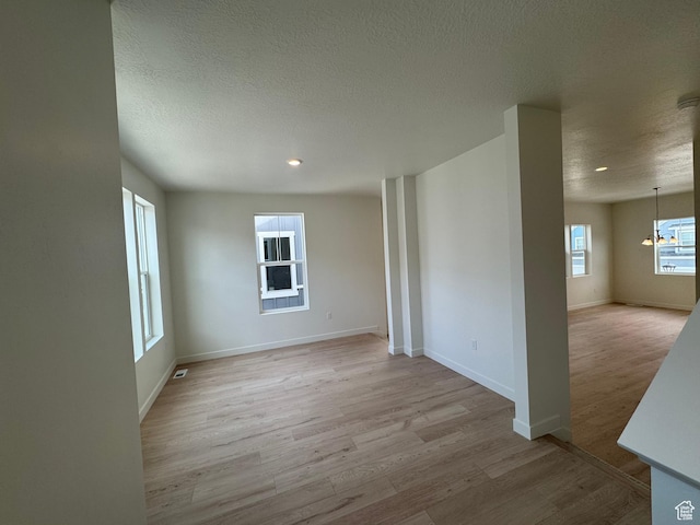 1668 N 1600 W Unit 128, Layton, UT 84041 - unfurnished room with light wood-style flooring, a textured ceiling, recessed lighting, and a chandelier