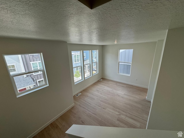 1668 N 1600 W Unit 128, Layton, UT 84041 - spare room with light wood-style floors and a textured ceiling