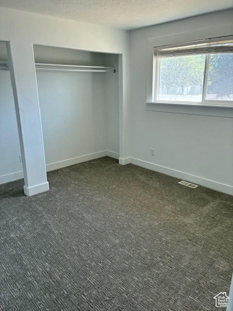 686 N 500 W, Orem, UT 84057 - unfurnished bedroom with carpet flooring, a textured ceiling, and a closet
