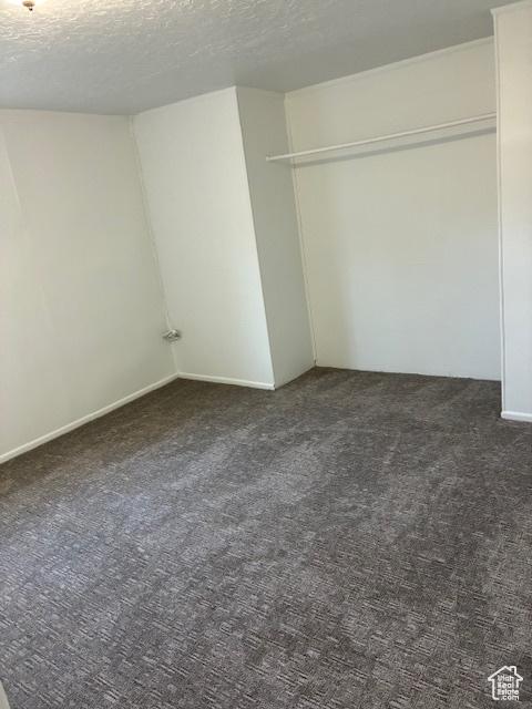 686 N 500 W, Orem, UT 84057 - unfurnished bedroom featuring dark carpet, a textured ceiling, and a closet