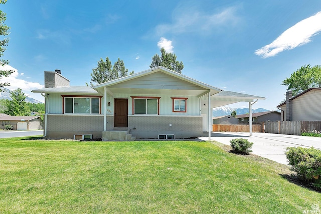 686 N 500 W, Orem, UT 84057 - view of front of home featuring brick siding, a chimney, driveway, and an attached carport