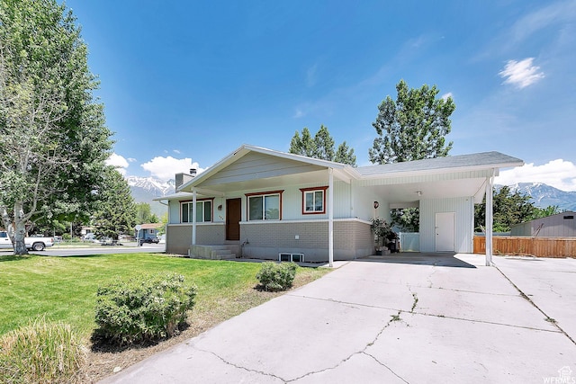 686 N 500 W, Orem, UT 84057 - view of front facade with driveway, a carport, a mountain view, covered porch, and a chimney