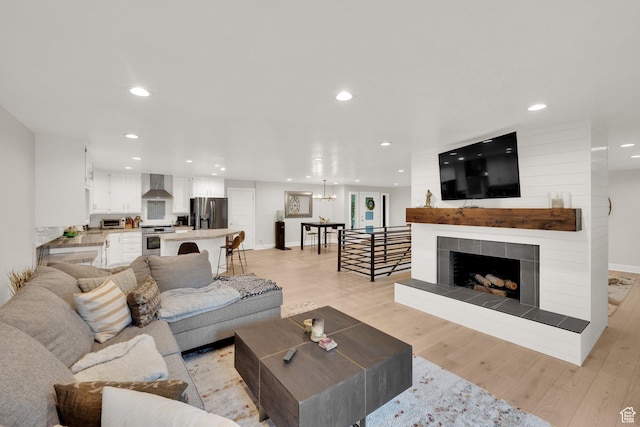 2345 E High Mountain Dr, Sandy, UT 84092 - living room featuring recessed lighting, light wood-style flooring, and a fireplace