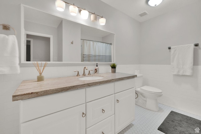 2345 E High Mountain Dr, Sandy, UT 84092 - full bathroom with tile walls, vanity, and wainscoting