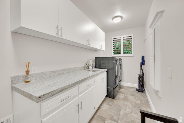 2345 E High Mountain Dr, Sandy, UT 84092 - washroom featuring washing machine and dryer, cabinet space, and stone finish flooring
