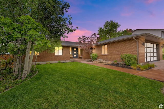 2345 E High Mountain Dr, Sandy, UT 84092 - view of front of home with brick siding, a garage, a yard, and concrete driveway