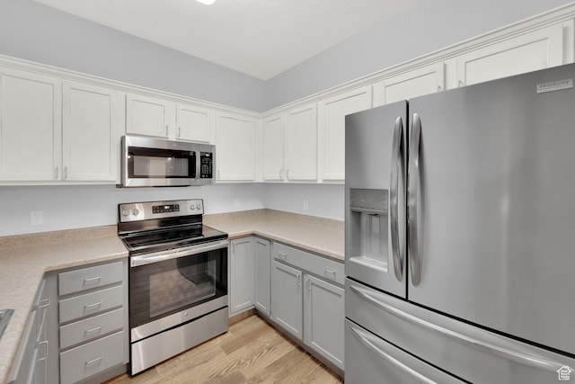 8728 S Black Diamond Cv W, West Jordan, UT 84081 - kitchen featuring stainless steel appliances, light wood finished floors, light countertops, gray cabinets, and white cabinetry