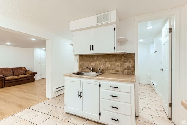 180 E Ross Dr, Clearfield, UT 84015 - kitchen featuring open shelves, light tile patterned flooring, baseboard heating, decorative backsplash, and recessed lighting