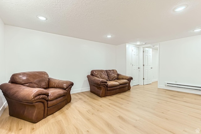 180 E Ross Dr, Clearfield, UT 84015 - living area with light wood-type flooring, baseboard heating, recessed lighting, and a textured ceiling