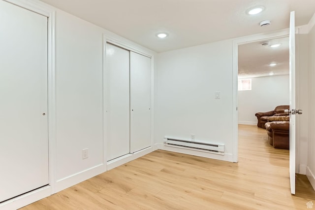 180 E Ross Dr, Clearfield, UT 84015 - bedroom featuring a baseboard heating unit, light wood-type flooring, and recessed lighting