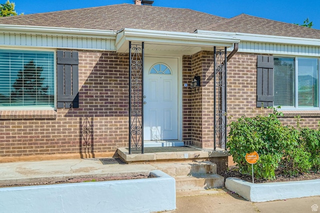 180 E Ross Dr, Clearfield, UT 84015 - doorway to property with brick siding and a shingled roof