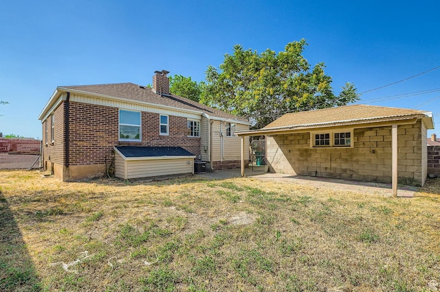 180 E Ross Dr, Clearfield, UT 84015 - rear view of house with a chimney and brick siding