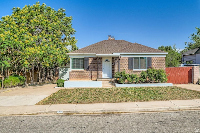 180 E Ross Dr, Clearfield, UT 84015 - bungalow-style home featuring brick siding, a chimney, driveway, and a shingled roof