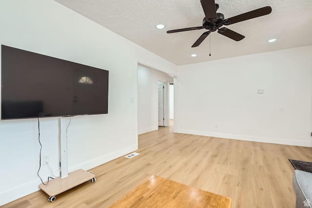 180 E Ross Dr, Clearfield, UT 84015 - unfurnished living room with light wood finished floors, a ceiling fan, recessed lighting, and a textured ceiling