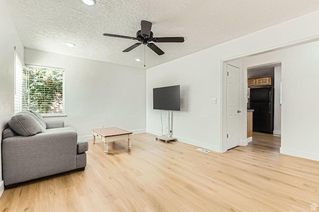 180 E Ross Dr, Clearfield, UT 84015 - living area with light wood-type flooring, a textured ceiling, a ceiling fan, and recessed lighting