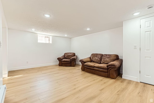 180 E Ross Dr, Clearfield, UT 84015 - sitting room with light wood finished floors, recessed lighting, a baseboard radiator, and a textured ceiling