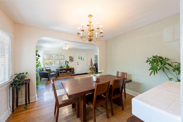1021 E 800 S, Salt Lake City, UT 84102 - dining space with arched walkways, light wood-type flooring, and a chandelier