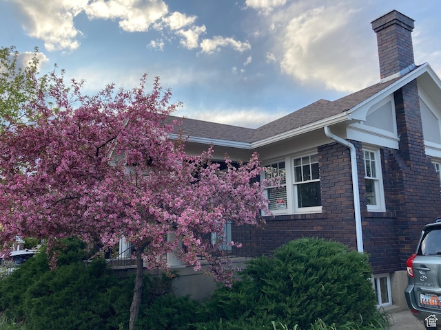 1021 E 800 S, Salt Lake City, UT 84102 - view of home's exterior with a chimney, a shingled roof, and brick siding