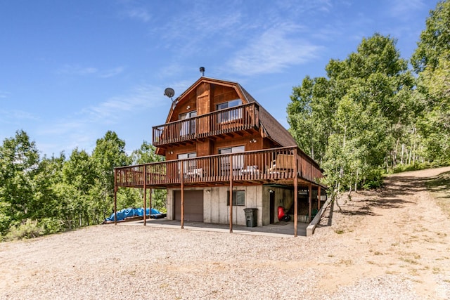 1922 N Corral Rd Unit 10, Scofield, UT 84526 - rear view of property with a gambrel roof, a garage, a deck, and driveway