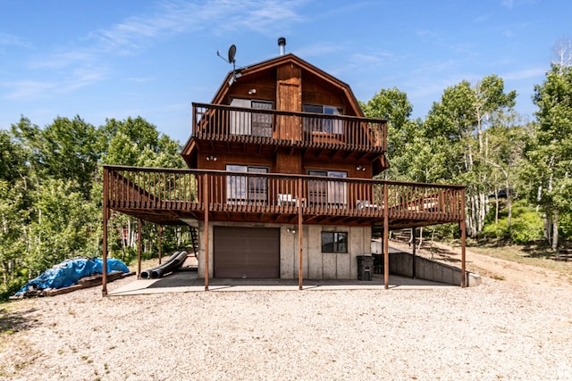 1922 N Corral Rd Unit 10, Scofield, UT 84526 - view of front facade featuring an attached garage, dirt driveway, a gambrel roof, and a deck