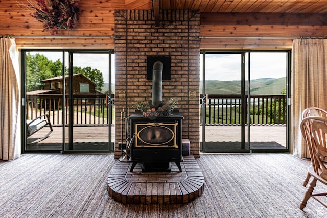 1922 N Corral Rd Unit 10, Scofield, UT 84526 - living room featuring wooden walls, a wood stove, wooden ceiling, carpet, and a mountain view