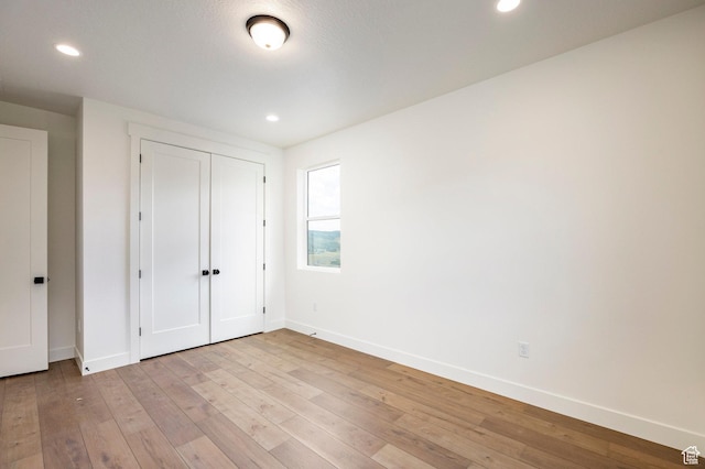 392 W Ascent Dr Unit 255, Hideout, UT 84036 - unfurnished bedroom featuring light wood-style flooring, recessed lighting, and a closet