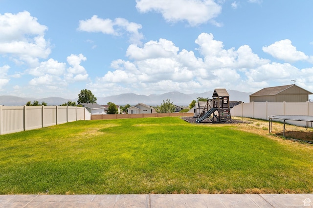 6959 S Adventure Way, West Jordan, UT 84081 - view of yard with a playground, a trampoline, and a mountain view