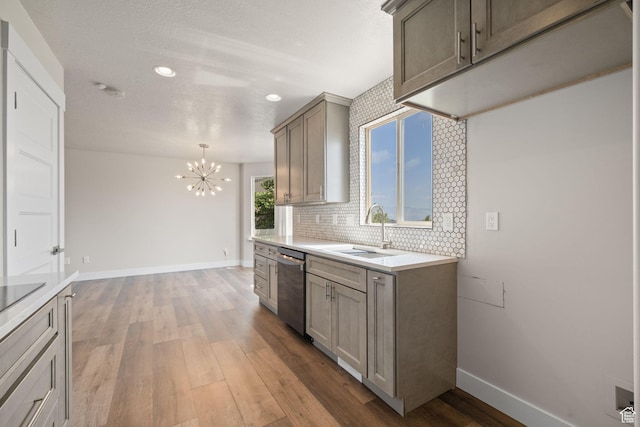 6959 S Adventure Way, West Jordan, UT 84081 - kitchen with stainless steel dishwasher, a chandelier, light wood finished floors, recessed lighting, and light countertops