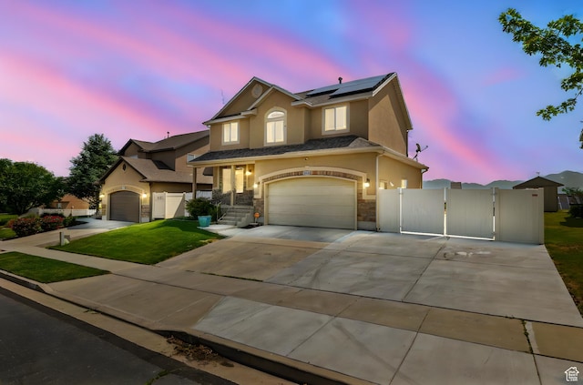 6959 S Adventure Way, West Jordan, UT 84081 - traditional-style house with a gate, stucco siding, solar panels, stone siding, and an attached garage