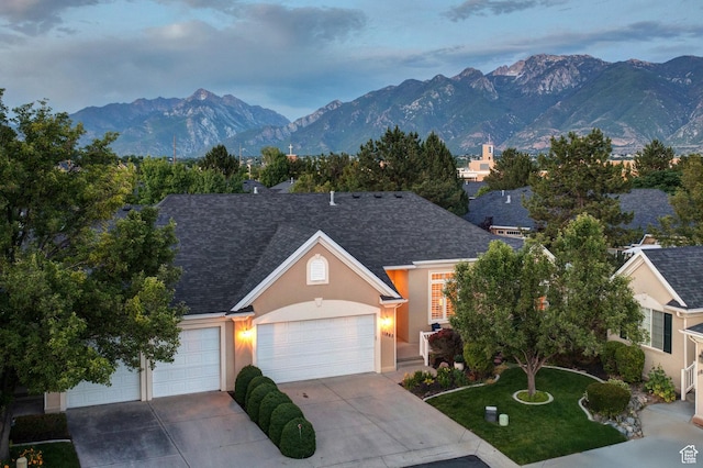 11863 S Cottage Side Way, Draper, UT 84020 - view of front of house with stucco siding, a mountain view, driveway, an attached garage, and a shingled roof