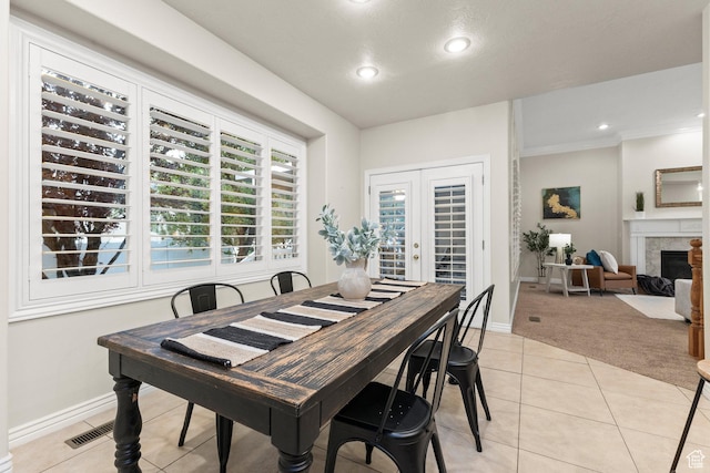 11863 S Cottage Side Way, Draper, UT 84020 - dining space featuring light colored carpet, light tile patterned flooring, a fireplace with flush hearth, recessed lighting, and ornamental molding