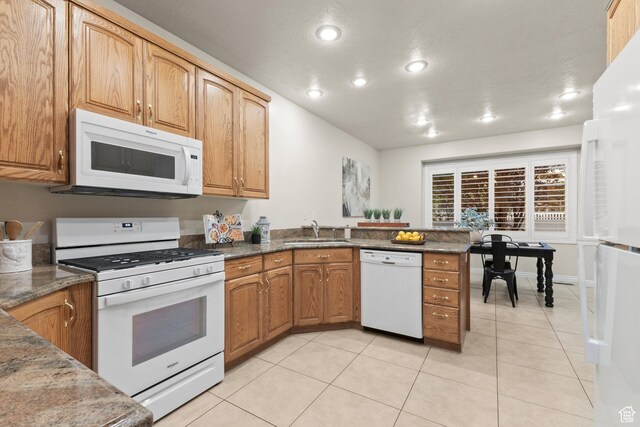 11863 S Cottage Side Way, Draper, UT 84020 - kitchen with white appliances, a peninsula, light tile patterned flooring, recessed lighting, and dark stone counters