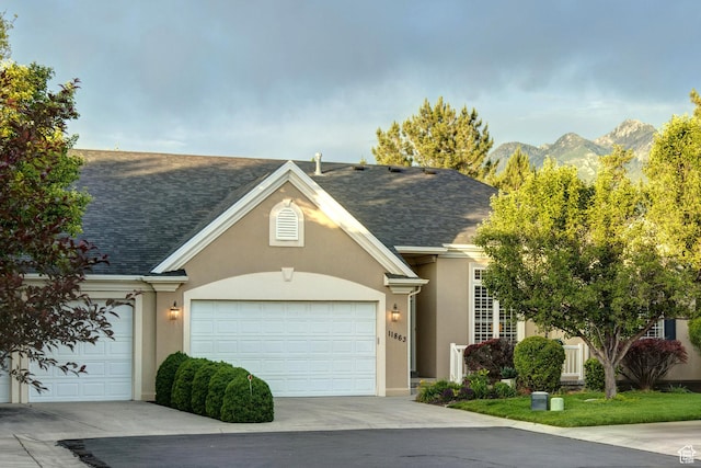 11863 S Cottage Side Way, Draper, UT 84020 - traditional home featuring stucco siding, a shingled roof, an attached garage, a mountain view, and concrete driveway
