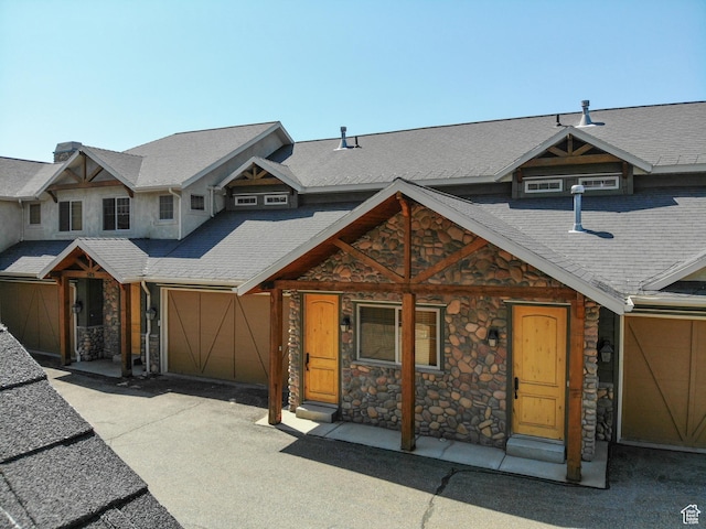 5176 E Fairview Loop Unit C505, Eden, UT 84310 - view of front facade with stone siding, a garage, and driveway