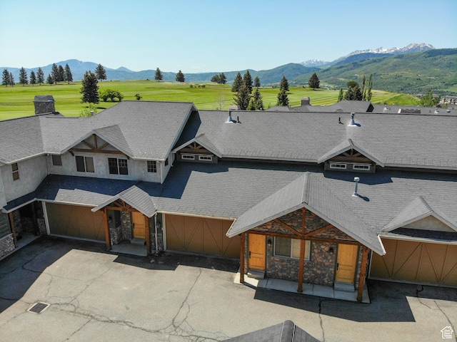 5176 E Fairview Loop Unit C505, Eden, UT 84310 - view of front facade with a mountain view, stone siding, driveway, and a porch