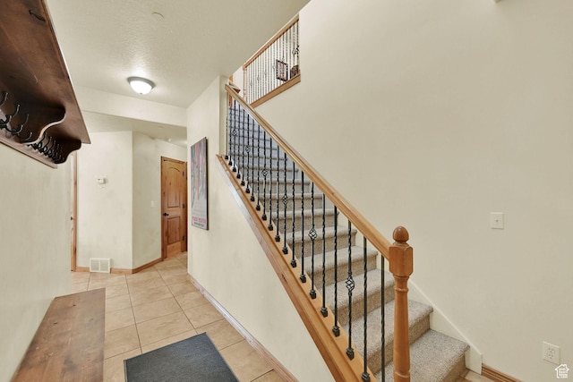 5176 E Fairview Loop Unit C505, Eden, UT 84310 - stairs with tile patterned flooring and a textured ceiling