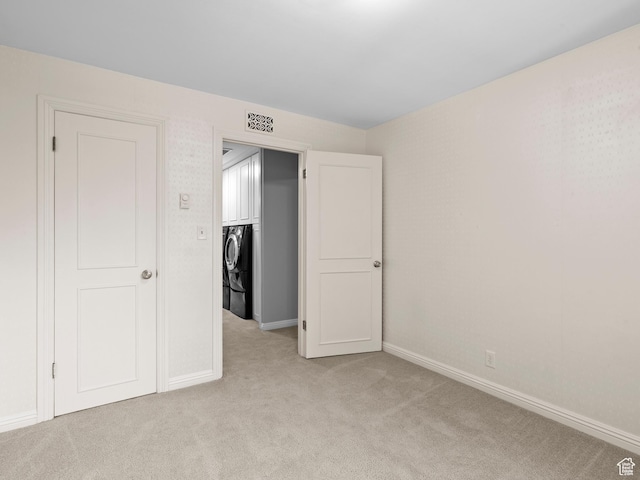 1150 E 2700 S Unit 50G, Salt Lake City, UT 84106 - unfurnished bedroom featuring washer and dryer and light colored carpet