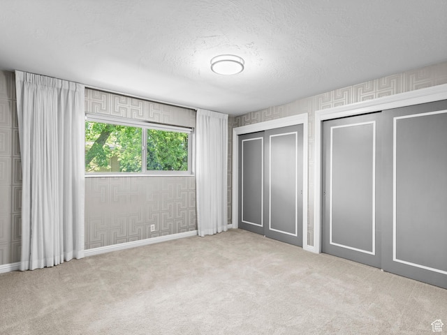 1150 E 2700 S Unit 50G, Salt Lake City, UT 84106 - unfurnished bedroom with two closets, carpet, and a textured ceiling