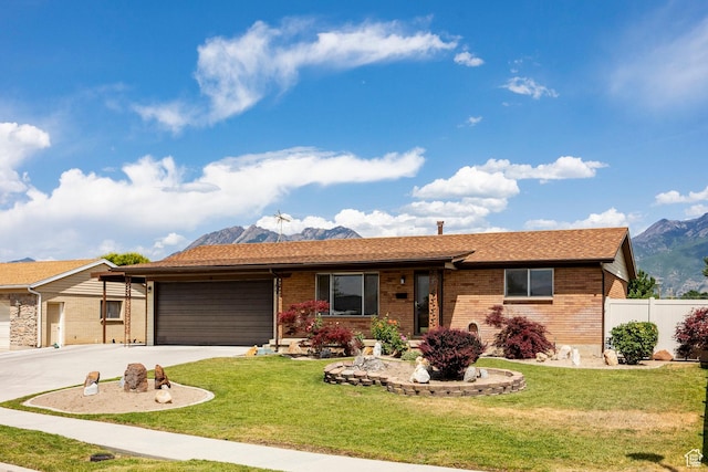 8097 S 535 E, Sandy, UT 84070 - single story home featuring a garage, brick siding, concrete driveway, and a mountain view